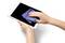 A person uses a blue microfiber cloth to clean the screen of a white tablet, highlighting proper maintenance of electronic devices.