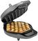 Bubble waffle iron with a partially baked waffle. The waffle has a fluffy, spherical structure and golden-brown colour.