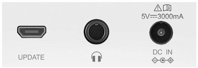 Front panel of an electronic device with connections: 'UPDATE' port on the left, headphone socket in the centre, 'DC IN' on the right for 5V, 3000mA.
