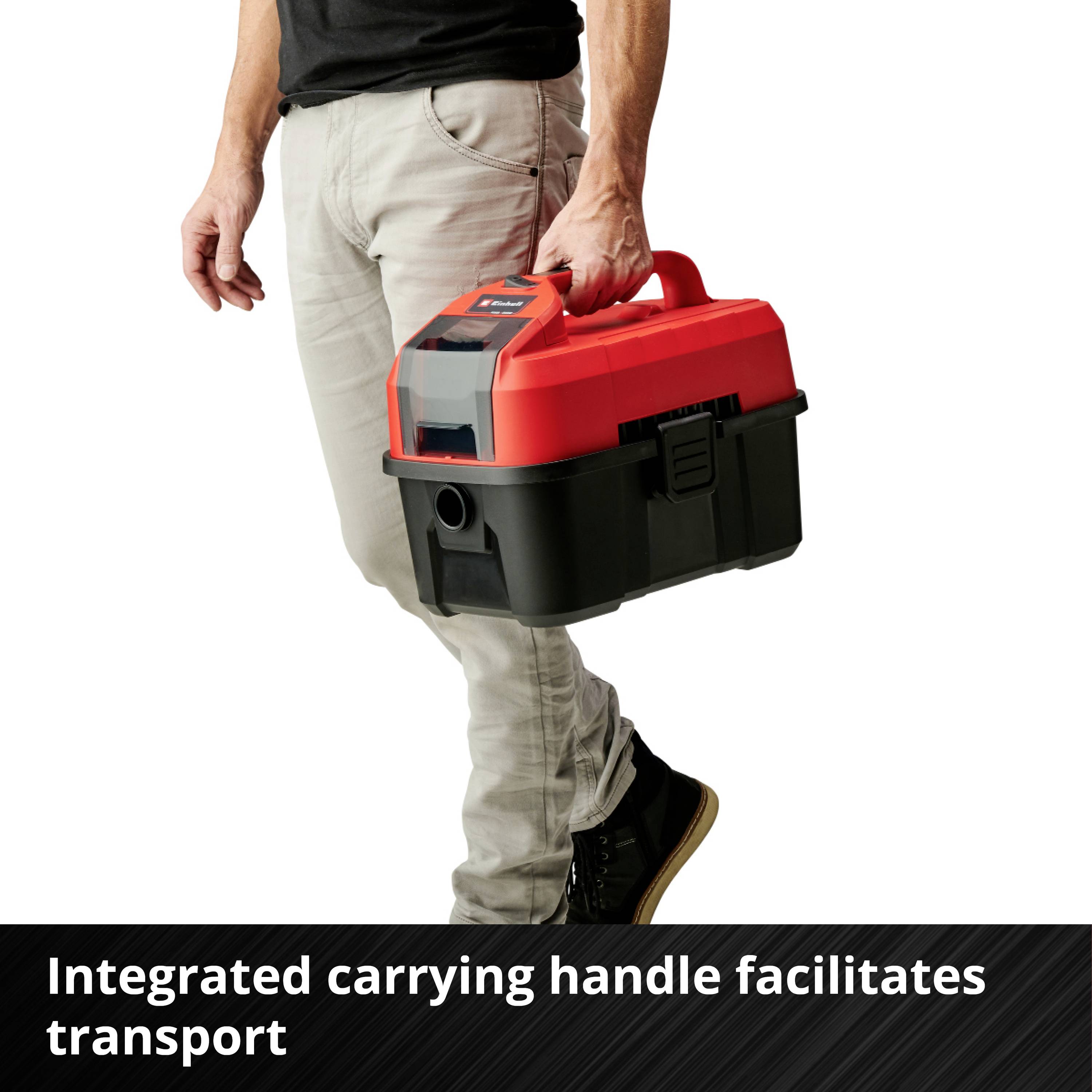 A person is holding a red and black tool case with an integrated handle for easy transport.