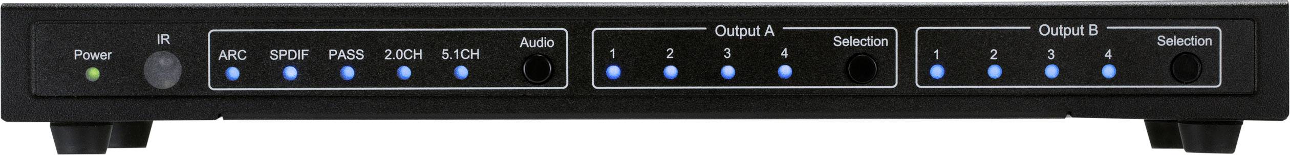 An audio device with indicator lights and sockets. The power LED is illuminated in green. Several input and output switches are visible.