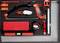 A red tool set in a foam insert contains a handsaw, a carpet knife, a spirit level, a tape measure, and other tools.