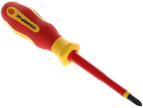 A red and yellow cross-head screwdriver lies diagonally, with an ergonomic handle and insulated tip.