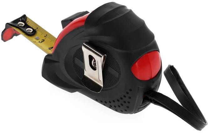 A black and red tape measure lies on a white background. The tape measure is partially pulled out and shows numbers for length measurement.