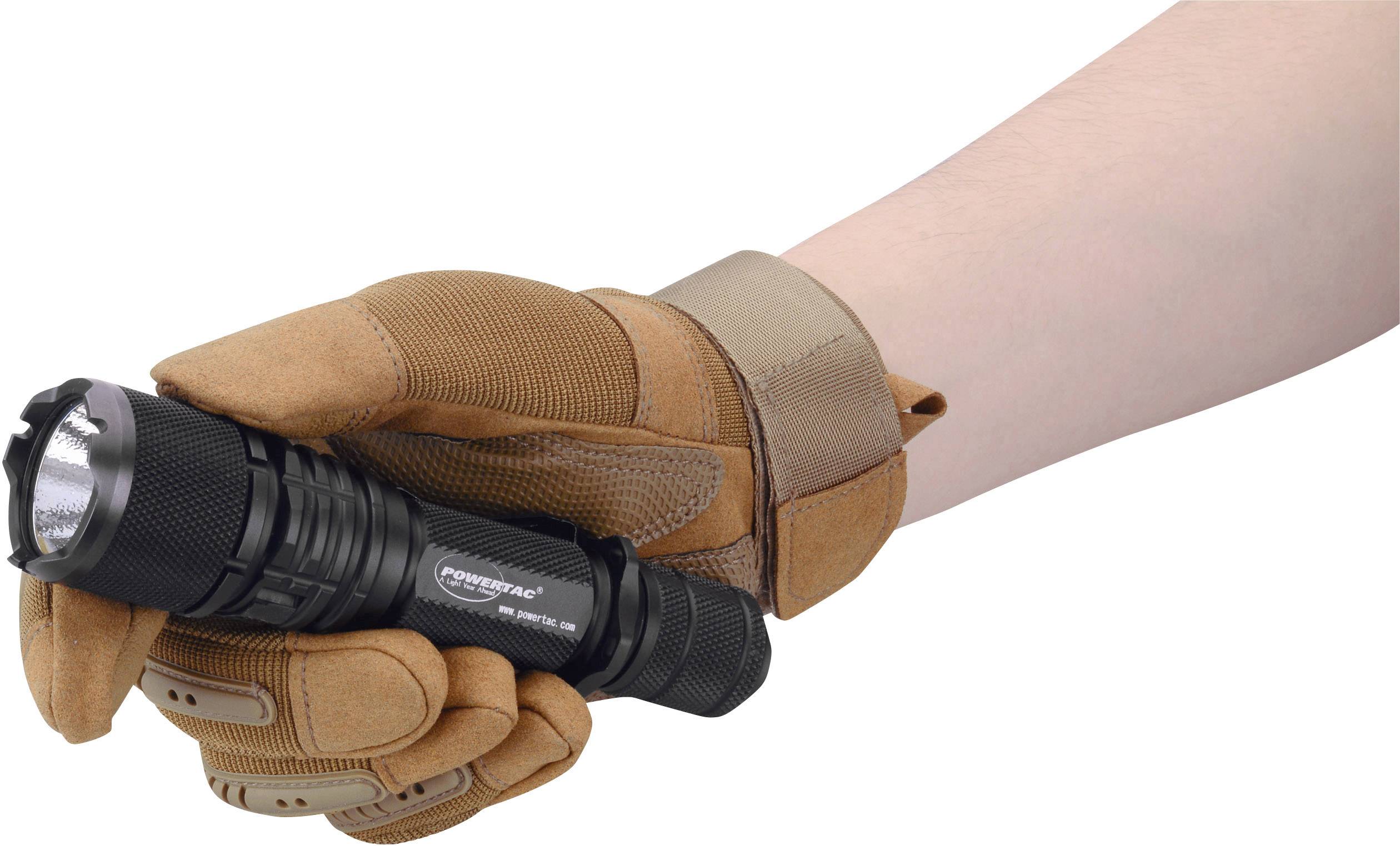 A hand in a brown glove is holding a black torch.