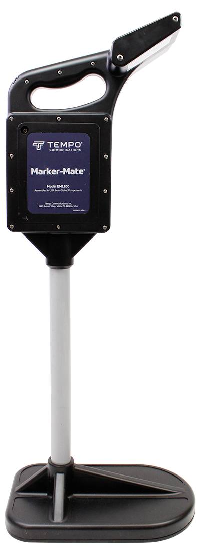 A black and silver device by Tempo, called the Marker-Mate. It has a handle on top and stands on a flat base.