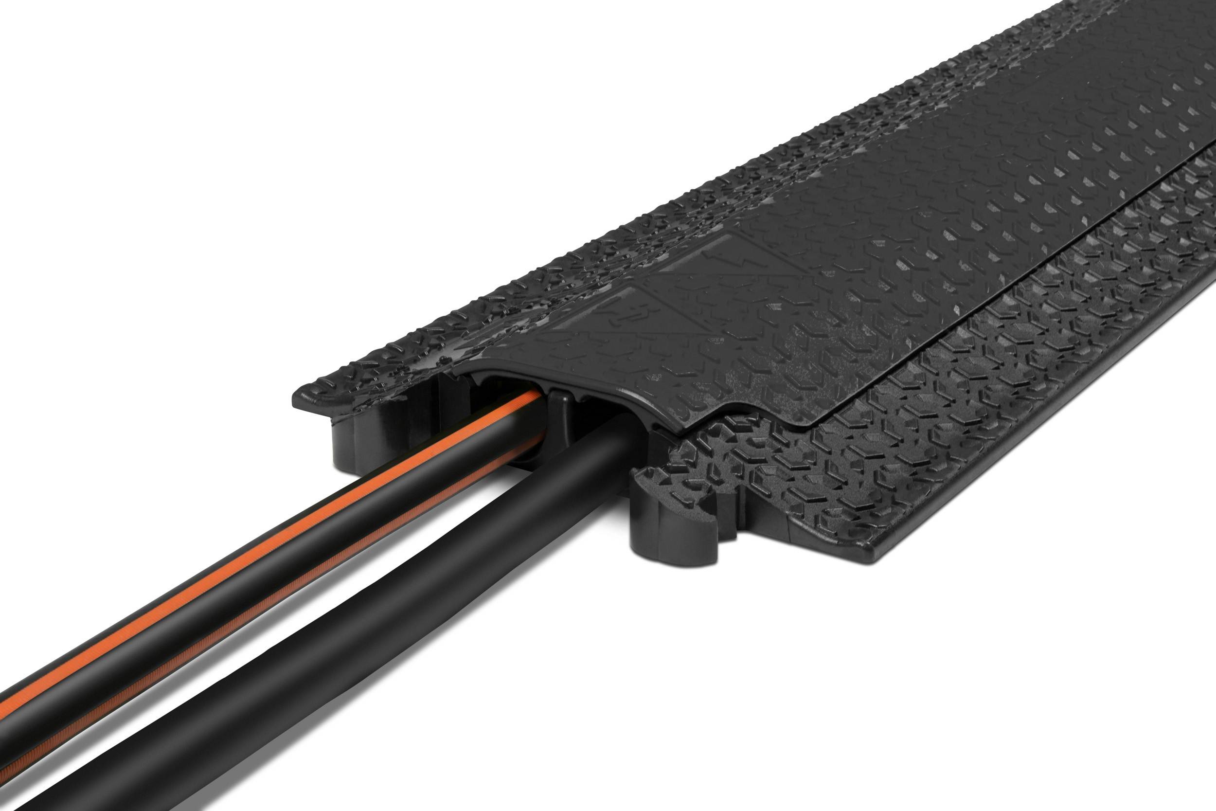Black rubber cable protector with a ramp-like design, featuring two orange cables guided through a protective channel.