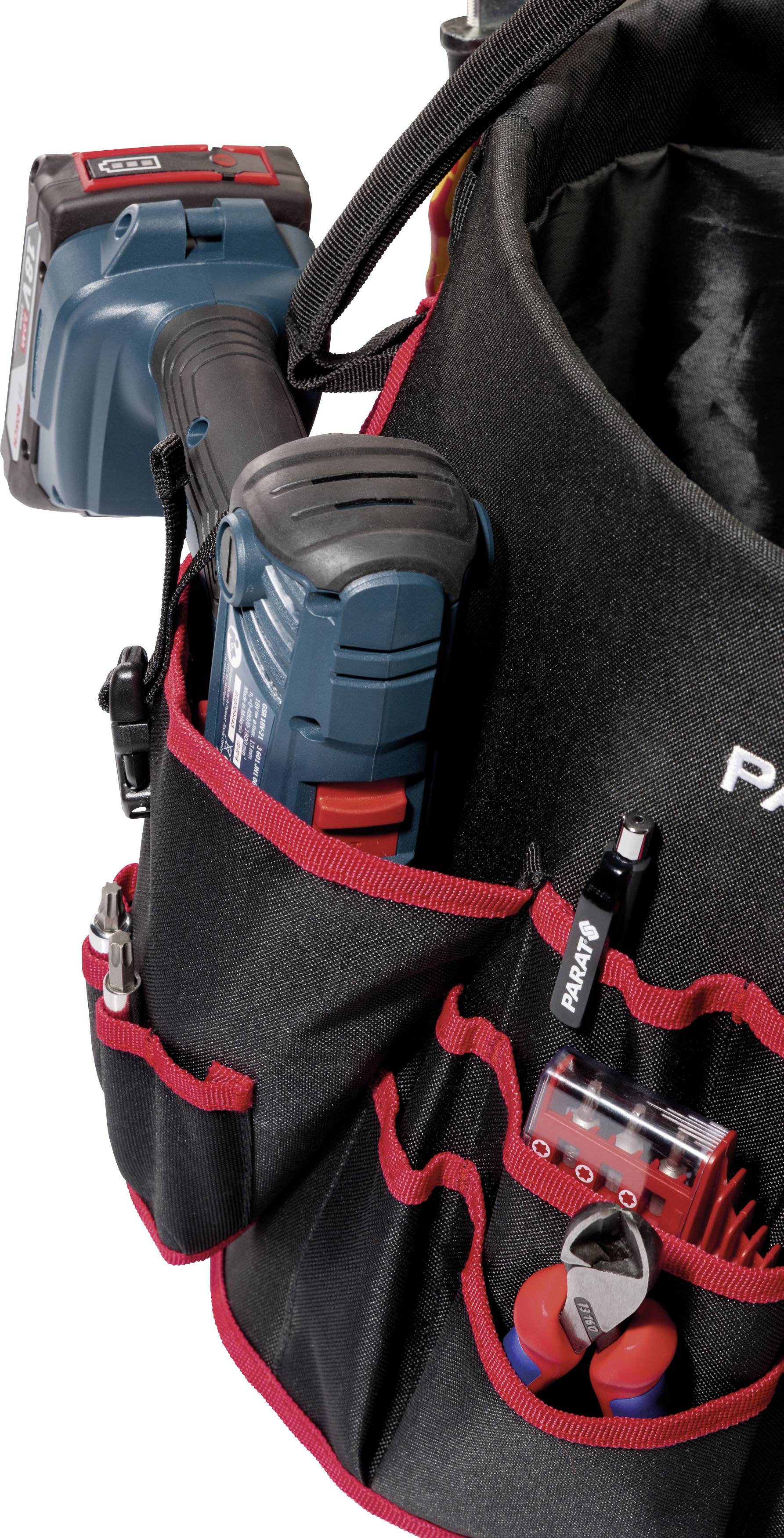 A tool bag with multiple compartments, containing various tools and a cordless drill.