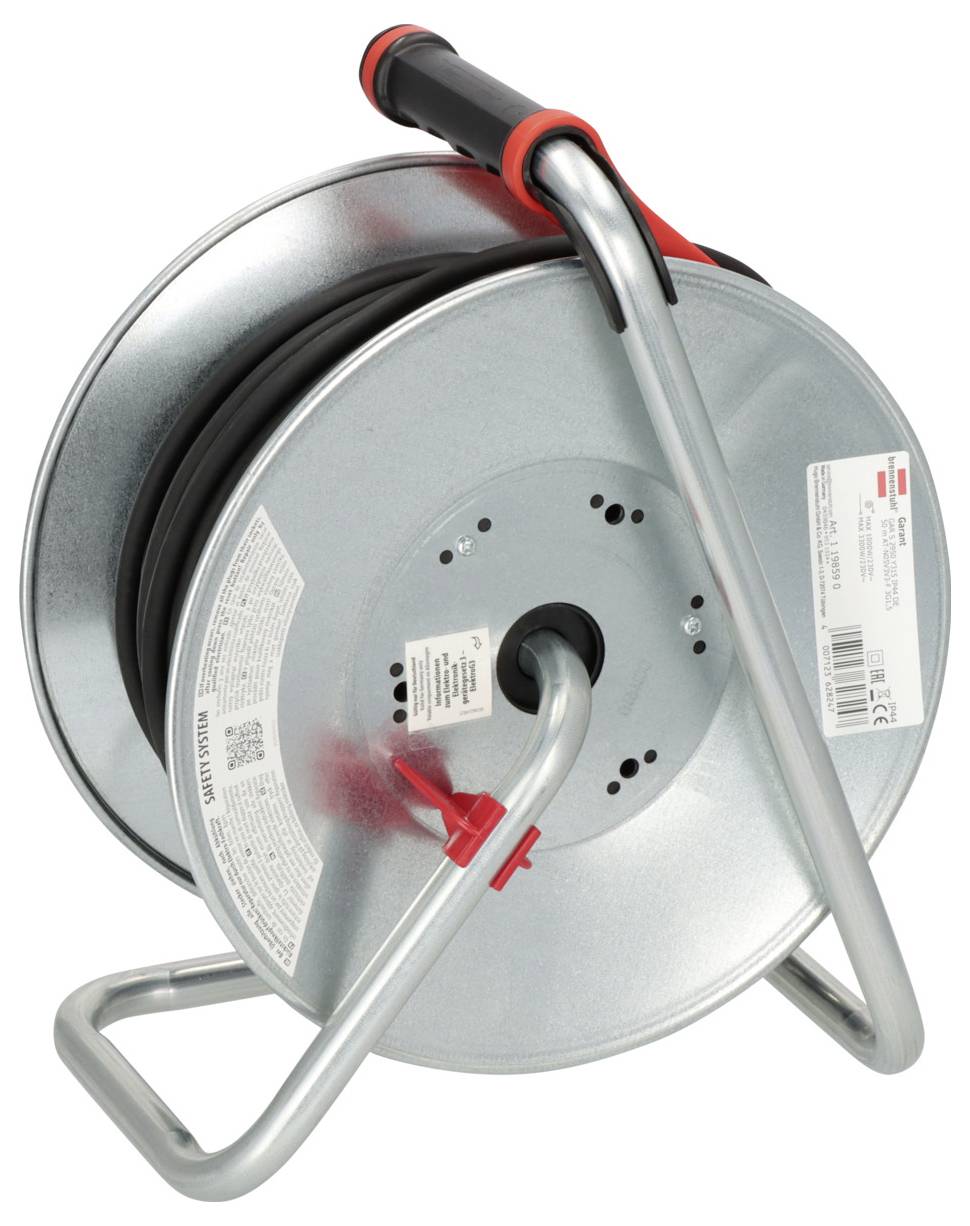 Portable cable reel on a metal stand with handle, showing coiled black cable and labels on the drum.
