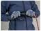 Person in gloves connecting two electrical cables using a black adapter, with one red cable and one black cable<br>