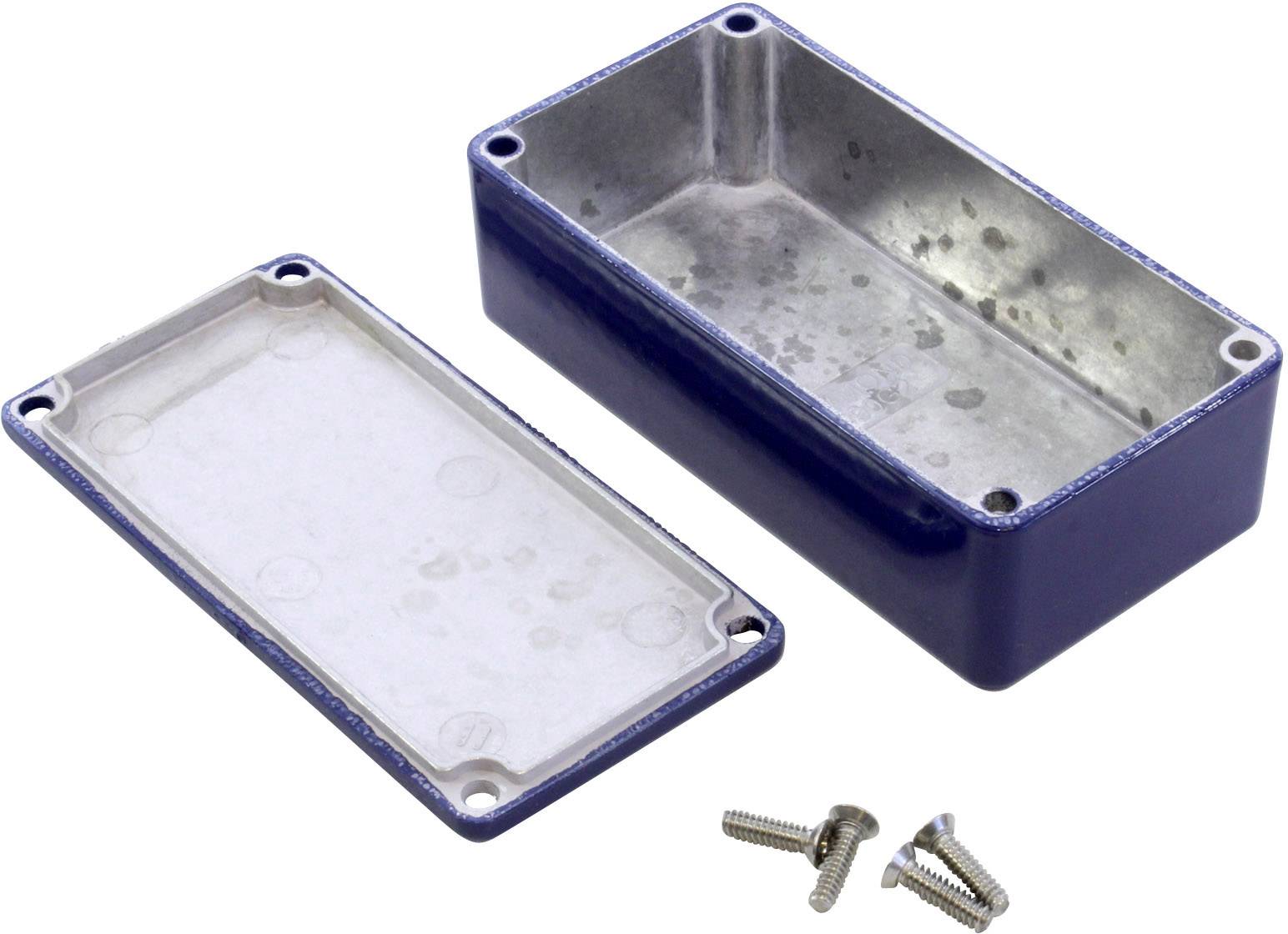 A rectangular metal electronics enclosure, opened with the cover removed. Four screws are lying beside it.