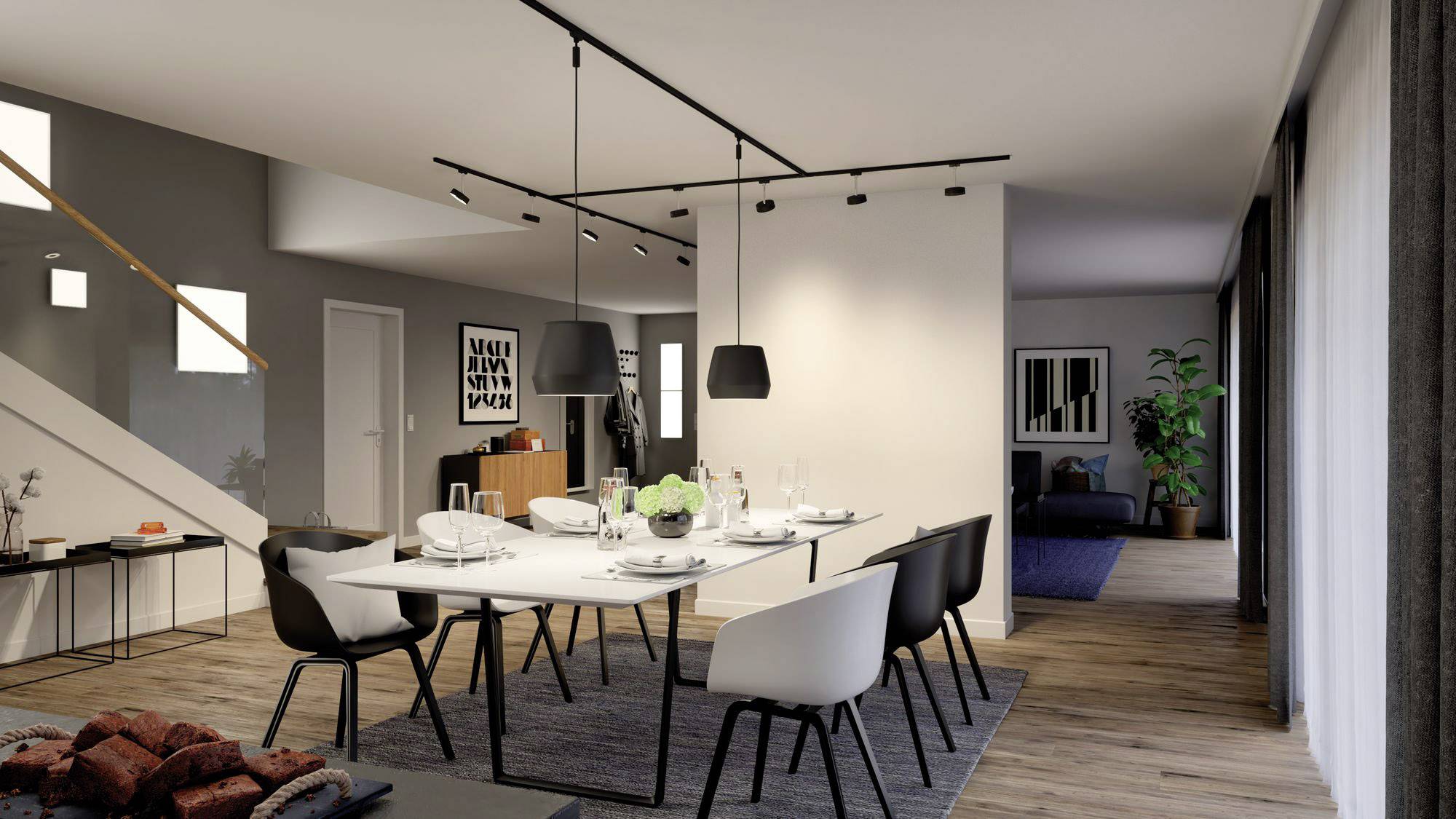 Dining room in a modern style with a large dining table, black chairs, and simple pendant lights. Bright walls, wooden flooring, and minimalist decor.