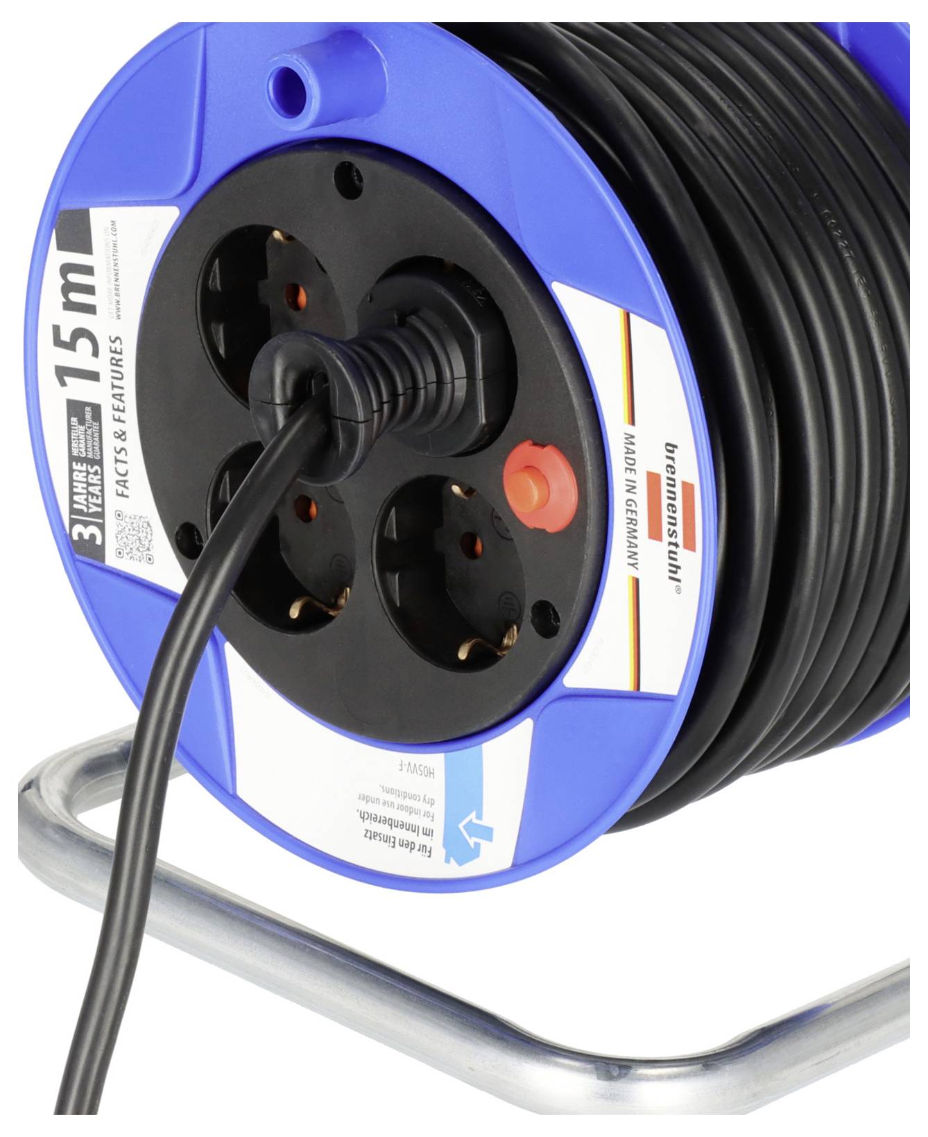 A blue cable reel with black sockets, an attached cable and a red button. Made in Germany, 15 m length.
