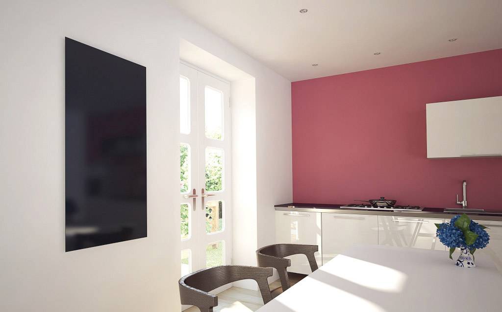 A modern, bright dining room with white walls and a red accent wall. Glass door with a garden view. Dark chairs, table, and flower bouquet.