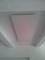 A large white rectangular ceiling panel mounted on a white wooden ceiling.