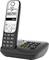 A cordless telephone with a digital display shows the number '08822995'. It is situated on a base station with an indicator light.