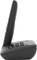Cordless telephone viewed from the side. Black model on charging station. Buttons and display visible.