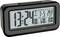 A woman is sleeping next to a digital alarm clock. The alarm clock displays the time, date, and temperature. Functions are listed.