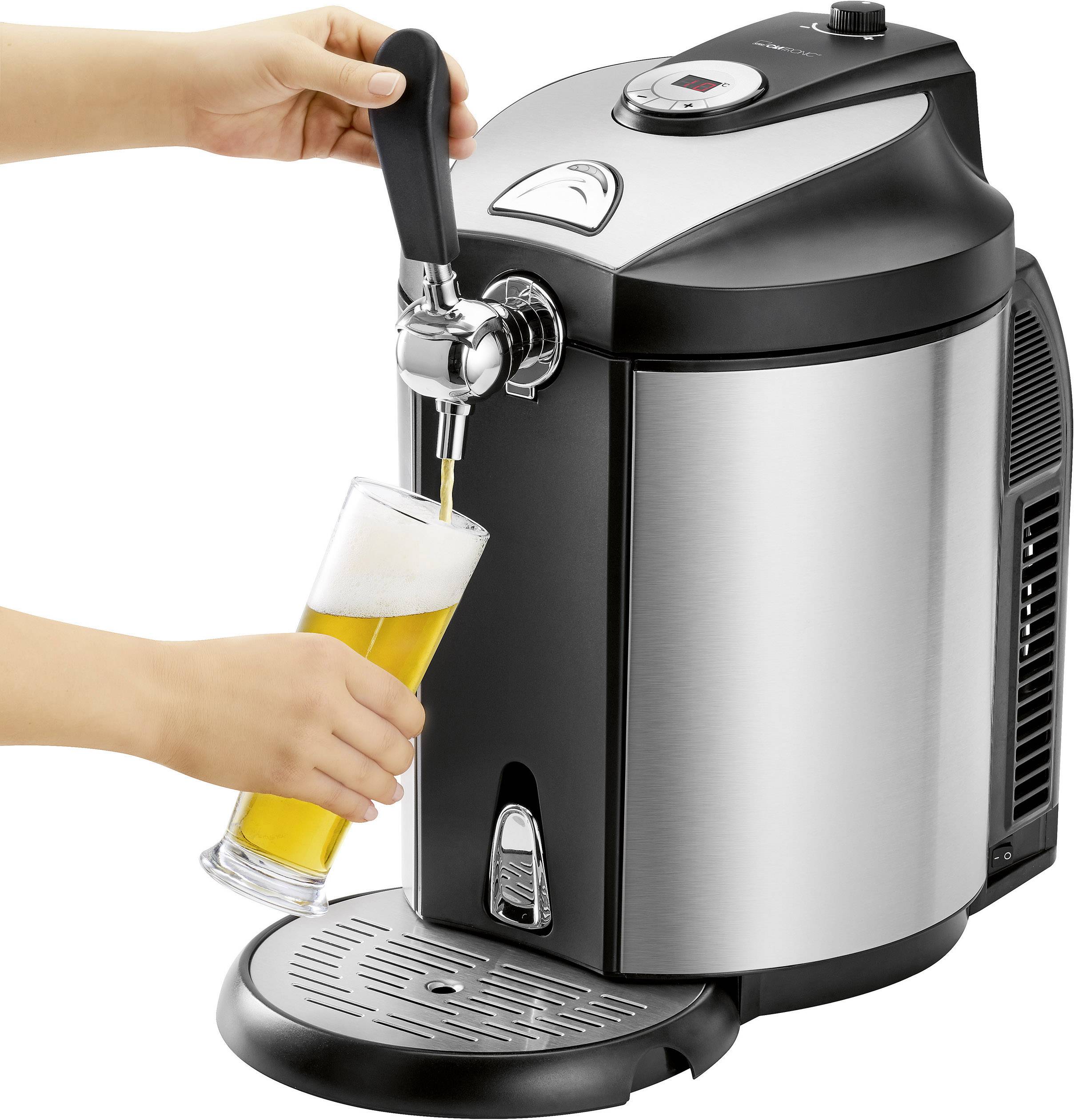 A person is drawing beer from a silver and black beer keg into a tall glass, which is standing on a drip tray.