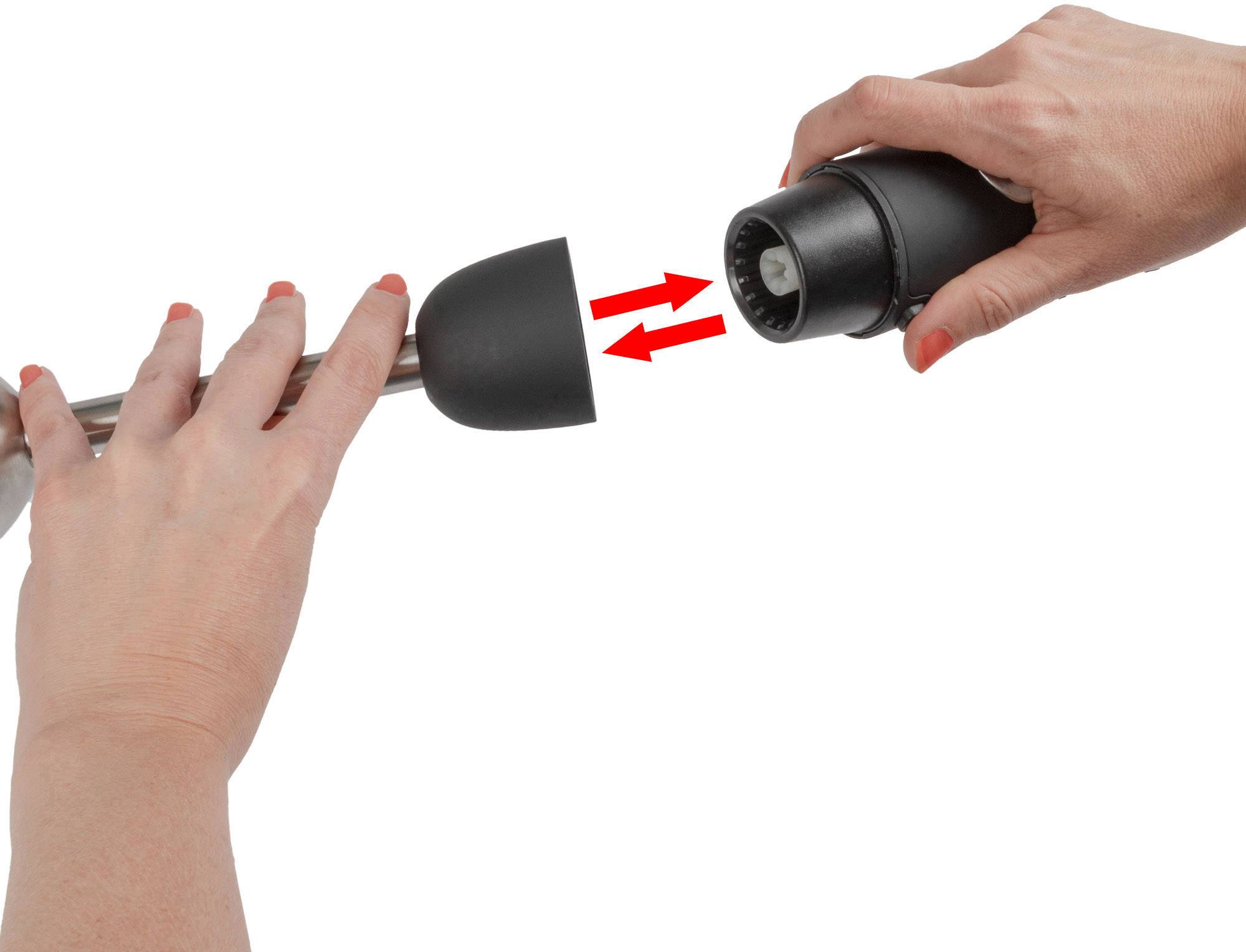 A person demonstrates assembling two parts of a hand blender by attaching the removable blade to the handle.