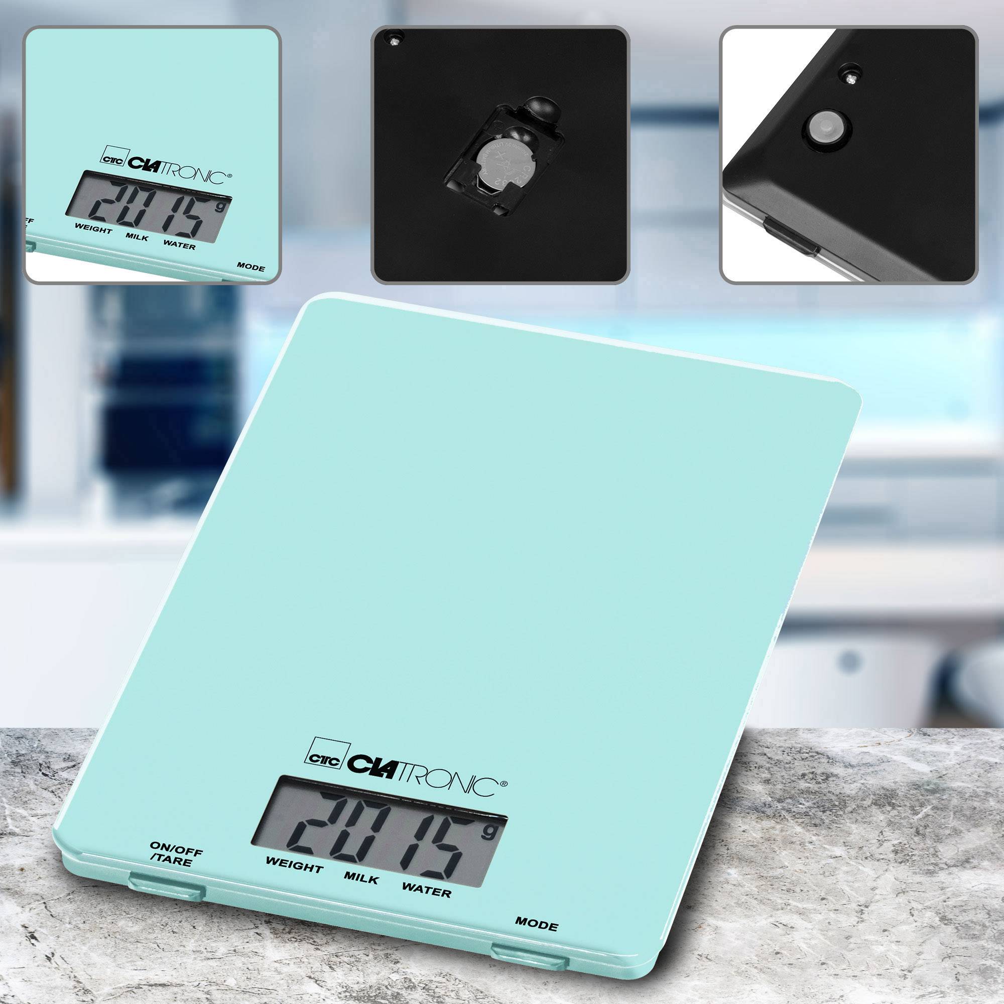 Turquoise digital kitchen scales with a digital display, showing weight and modes such as milk and water. Background depicts a blurry kitchen environment.