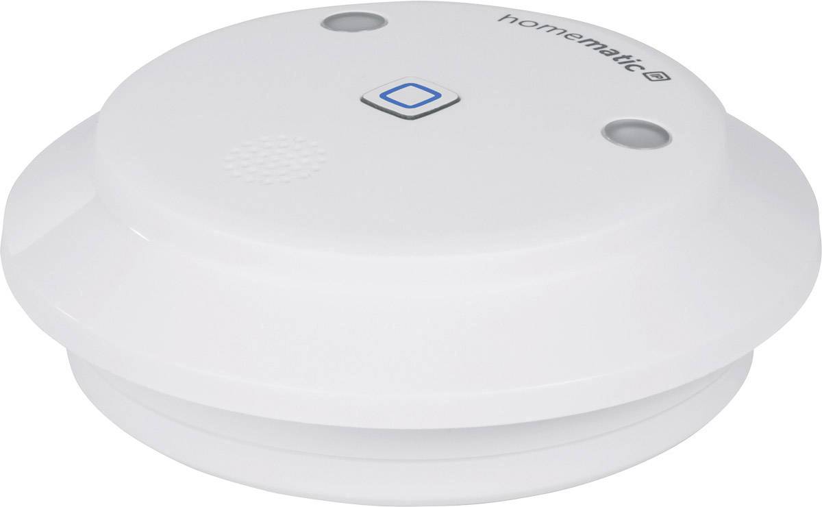 A white smoke detector with a central test button and two sensors. The model name 'homematic' is visible on the top surface.