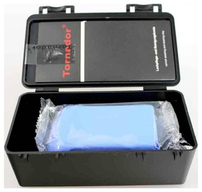 'A Tornador black box open, containing a blue cleaning tool wrapped in plastic. The box has product branding and description inside the lid.'