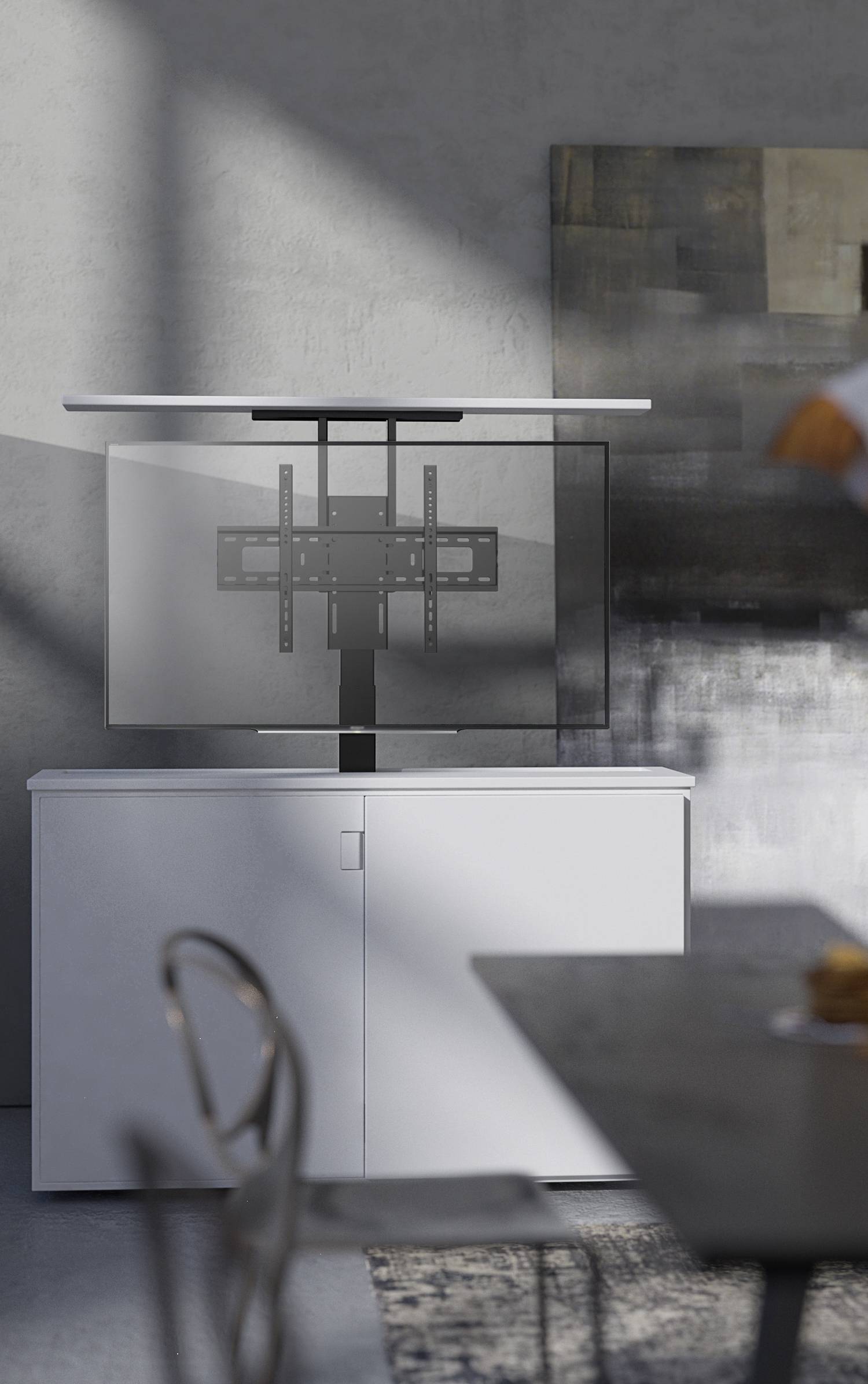 A contemporary space with a white wardrobe, above which a wall mount for a television is installed without a screen. Shadow plays on the wall.