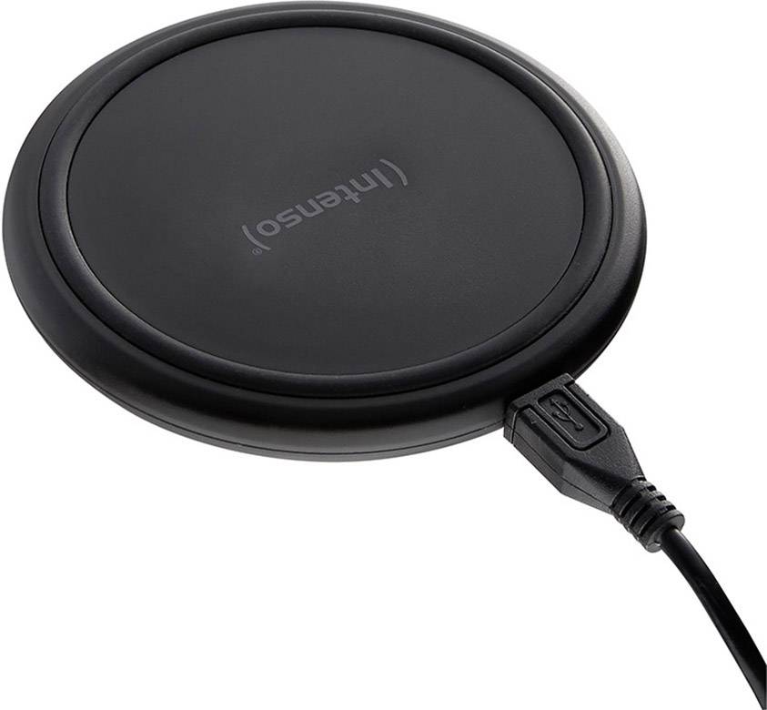 Black, round wireless charger from Intenso with USB port, lying on a light surface.