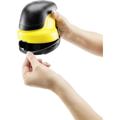 A person is holding a yellow window cleaning device in their hands. The lower cover of the device is being removed.