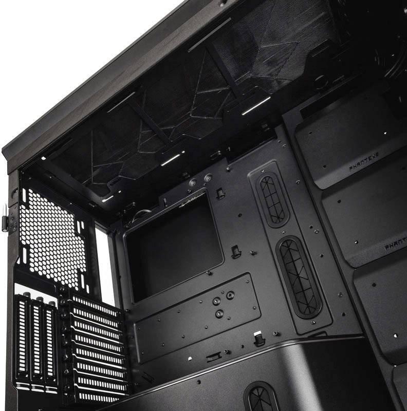 Black computer case at an angle, showing empty slots for fans, expansion cards, and drives. Interior space without components.