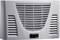 Wall-mounted air conditioning unit with ventilation slots and control panel on the front.