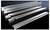 Metal rack rails on a black background, arranged in parallel rows.