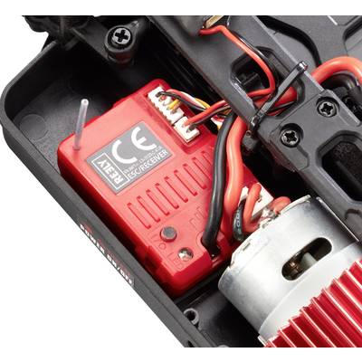 Close-up of an RC car gearbox with a red receiver, wired connections, and a motor. Central to the vehicle's control.