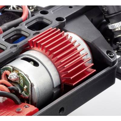 A red heatsink is mounted on an electric motor in a technical device. Wires are connected to the motor.