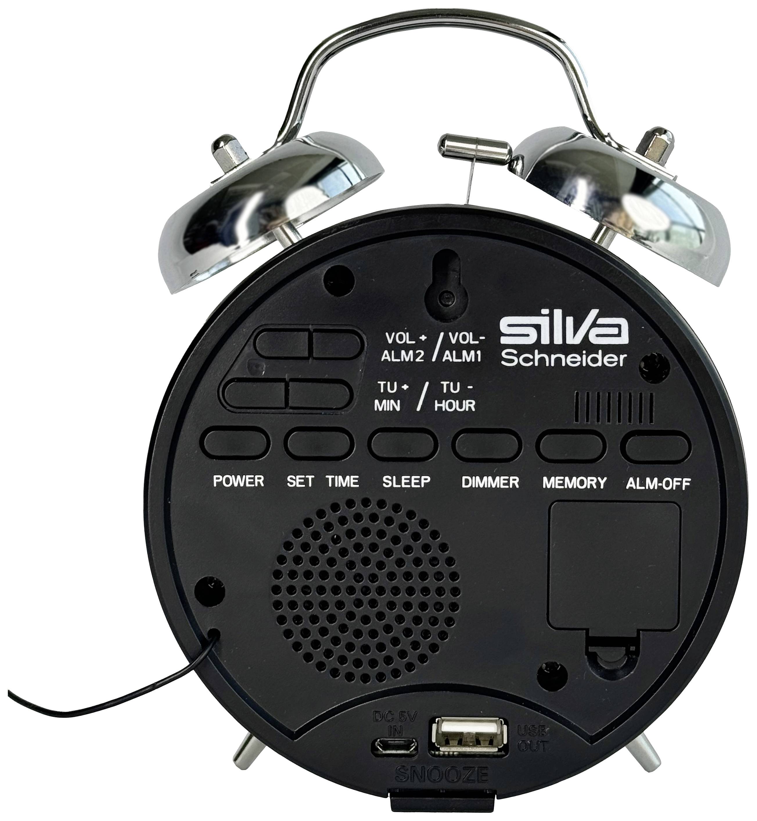 A black alarm clock with silver bells shows its back view. Visible are controls for volume, alarms, power, set and USB port.