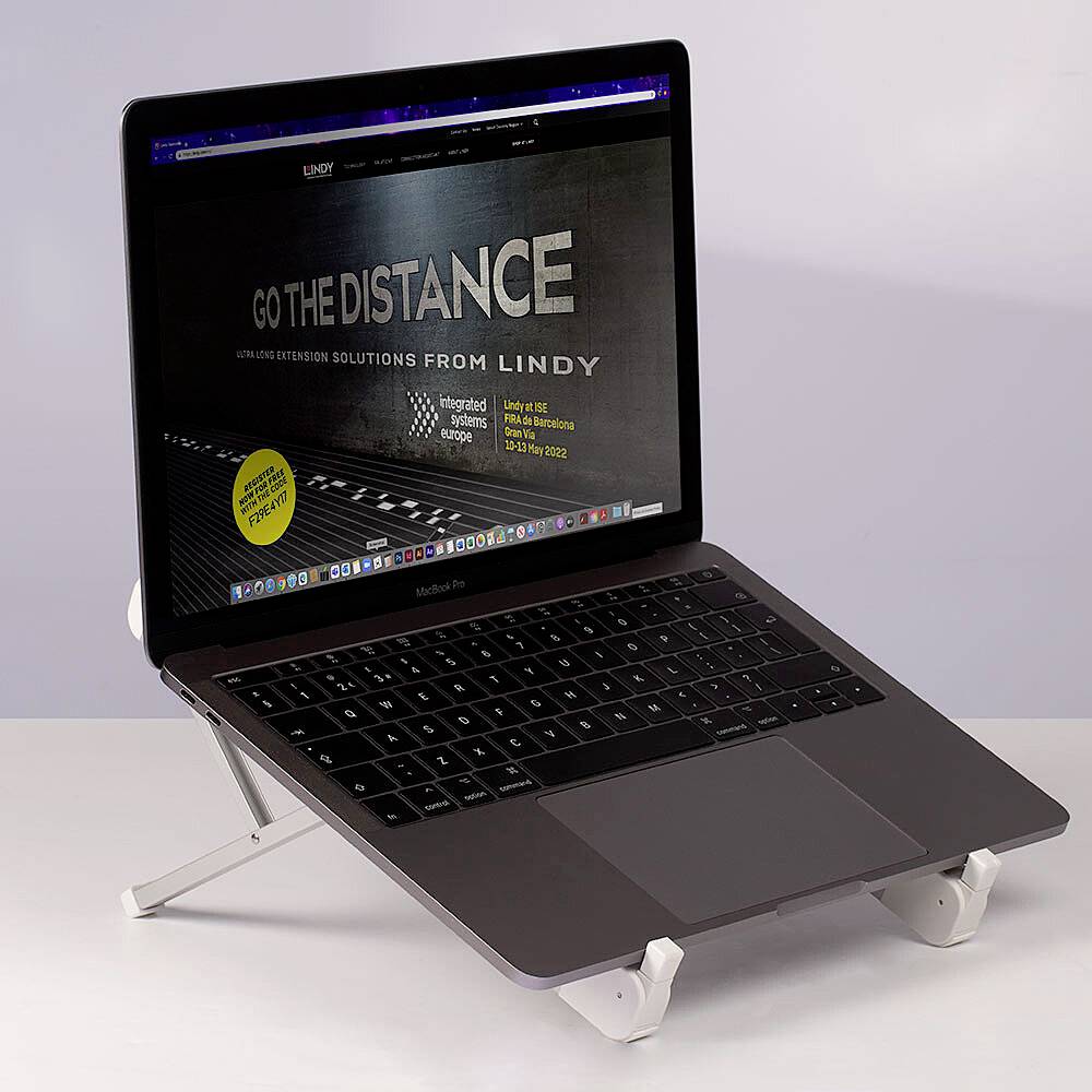 A laptop on a stand, displaying a website titled 'Go the Distance', presumably about connectivity solutions.