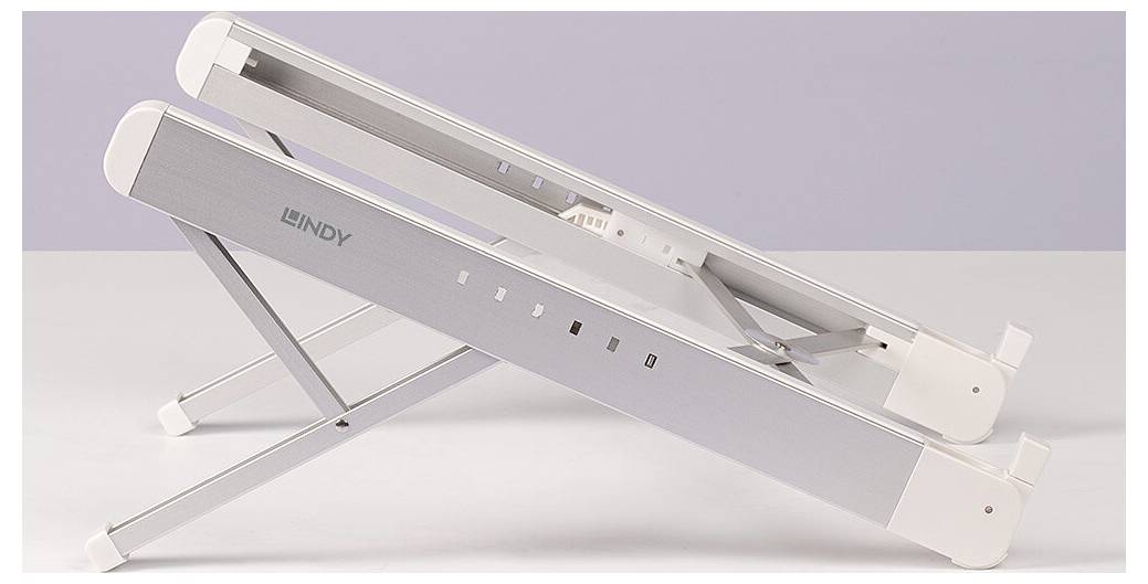 A silver laptop stand viewed from the side, folded, shows the 'Lindy' logo. Suitable for stabilising laptops.
