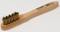 Wooden-handled brush with brass bristles, suitable for cleaning or abrasive work. Barcode label visible on the handle.