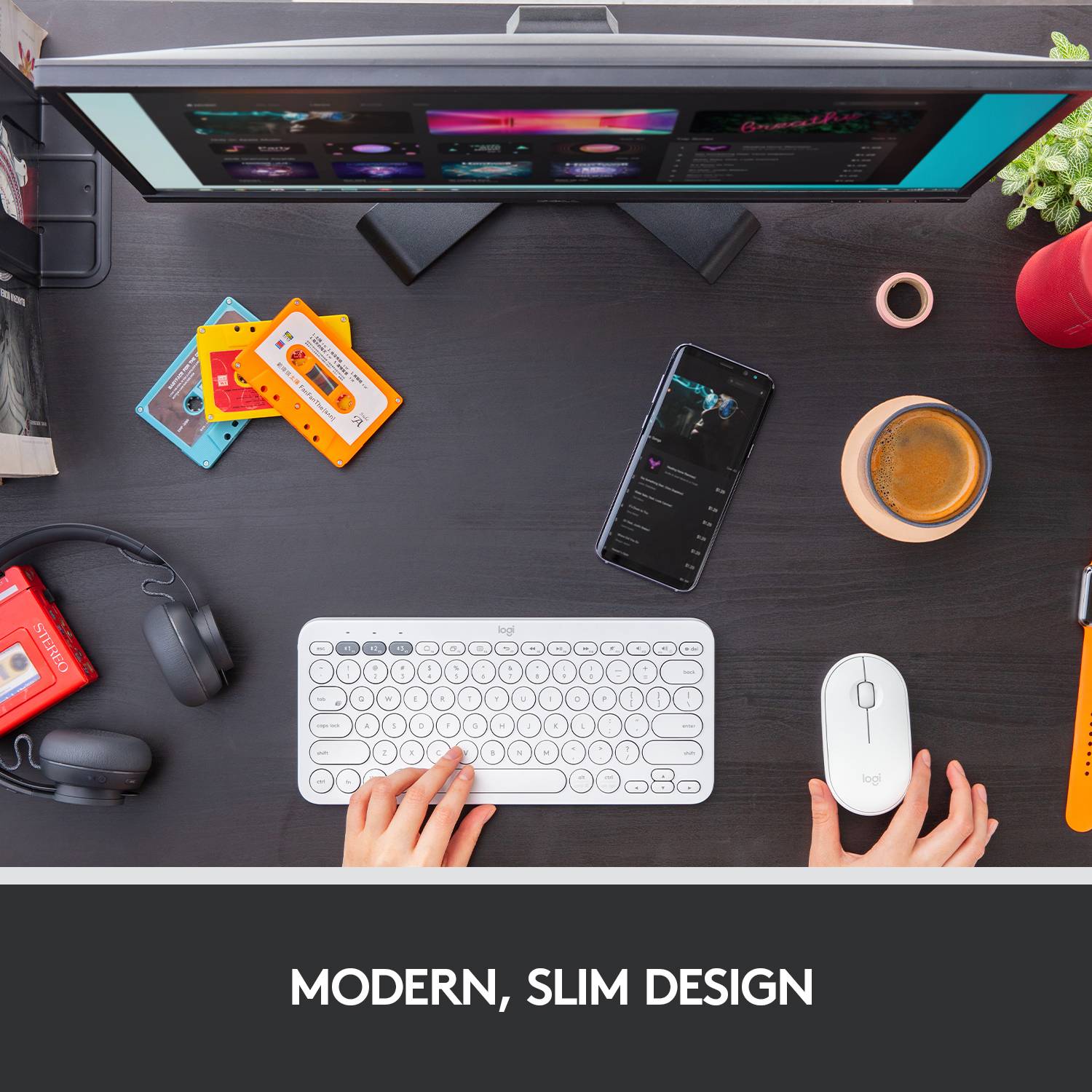 A desk with keyboard, smartphone, headphones and drink, title: 'Modern, Sleek Design'.