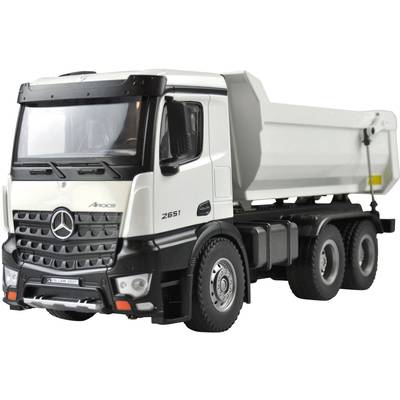 White and black tipper lorry parked on a closed car park.