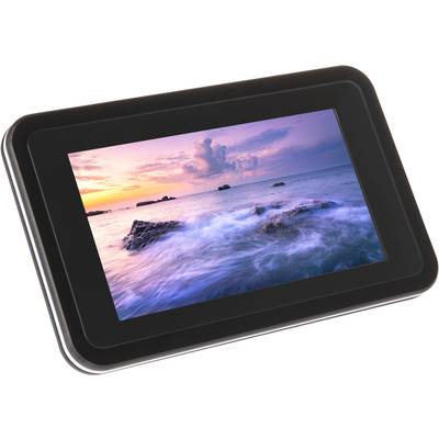 A digital photo frame displays a coastal scene at sunset with a colourful sky and gentle waves lapping against rocks.