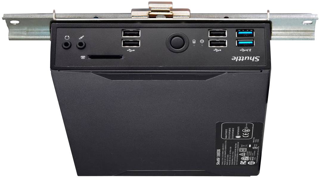 Compact black mini PC with multiple USB ports and a power button on the front panel, mounted on a metal rail.