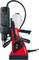 A red and black electric power drill with a handle, control buttons, and a hose on top.