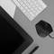 Graphics tablet, microphone, and keyboard arranged on a desk. Ideal for digital creative work.