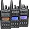 Three black two-way radios with illuminated displays, each showing different colours: Orange, Blue and Purple.