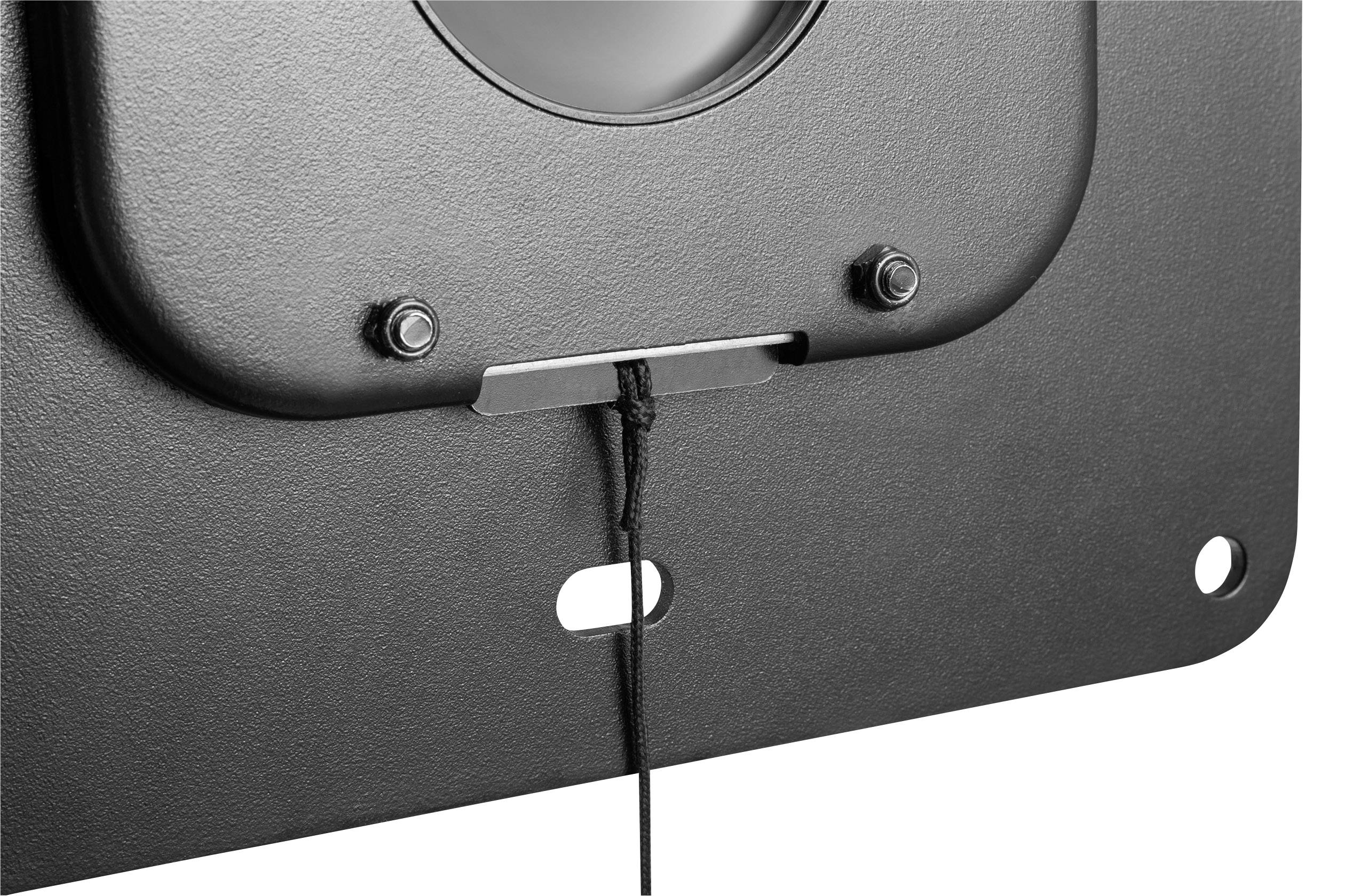 Close-up of a black speaker with two screws on the top and a protruding black cable at the bottom.