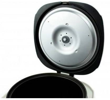 An open pressure cooker lid with a visible inner lid and sealing ring.