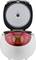 Rice cooker with lid open, showing a digital control panel on the front. The appliance is designed in white and red.