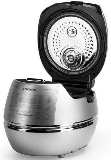 Rice cooker with open lid, showing the interior. Control panel at the front with multiple buttons. Modern, shiny stainless steel surface.